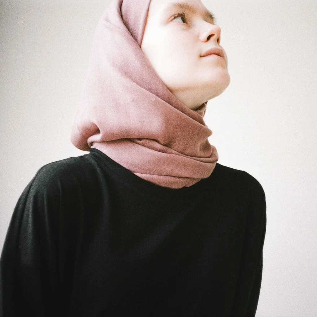 A sister stretching on a mat in soft natural light.